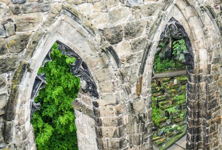 Gothic windows and the cloister graveyard.